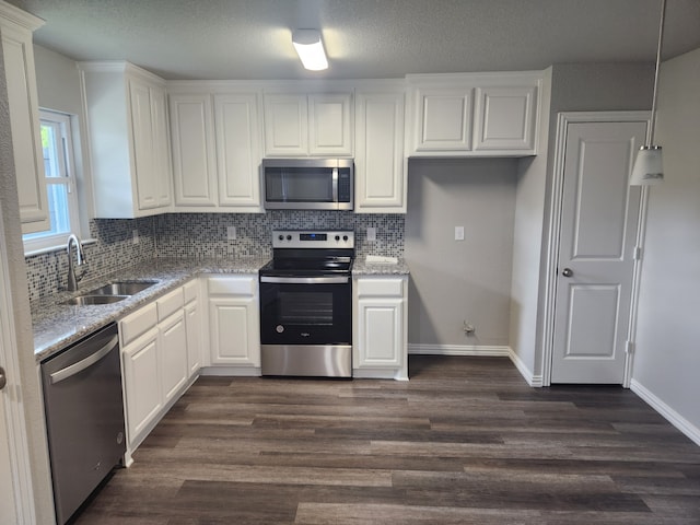 kitchen featuring stainless steel appliances, sink, dark hardwood / wood-style flooring, and white cabinets