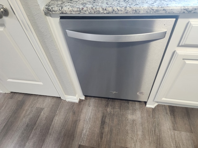 room details featuring white cabinets, dishwasher, and dark hardwood / wood-style flooring