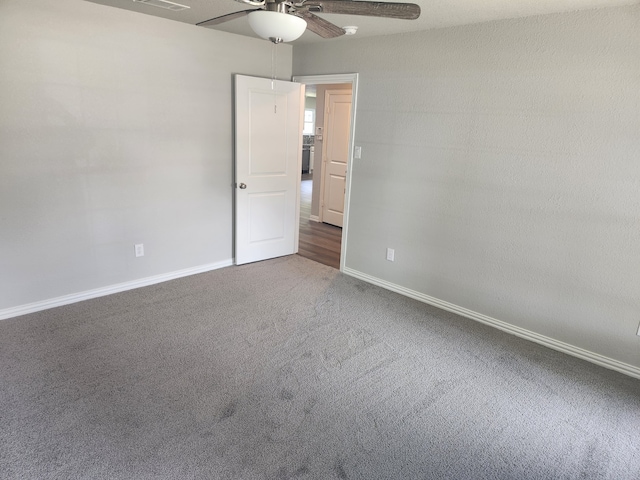 empty room with ceiling fan and carpet flooring