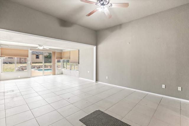 unfurnished living room with a healthy amount of sunlight, ceiling fan, and light tile patterned floors