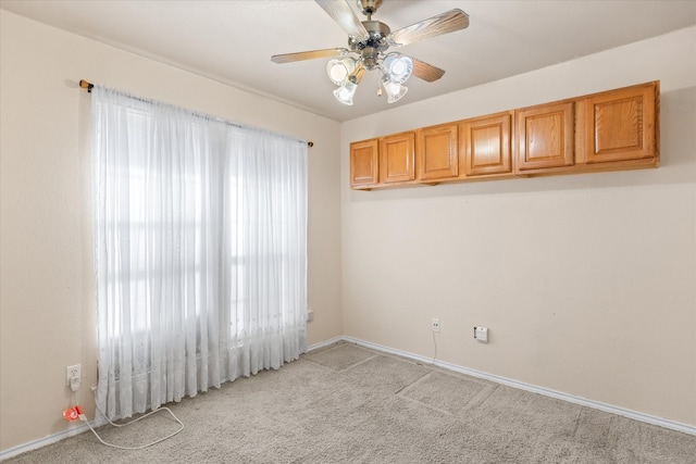 unfurnished room featuring light carpet and ceiling fan