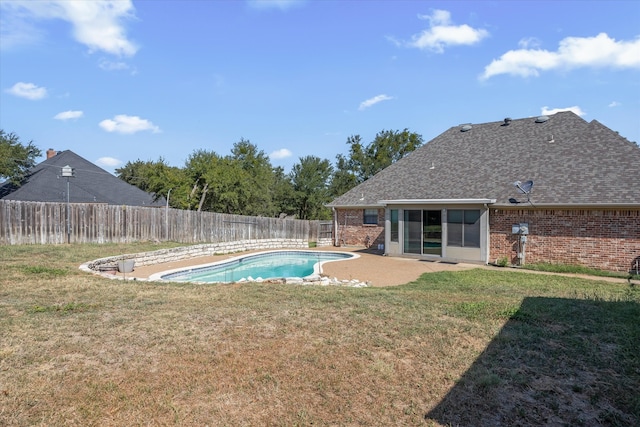 view of pool featuring a lawn and a patio area