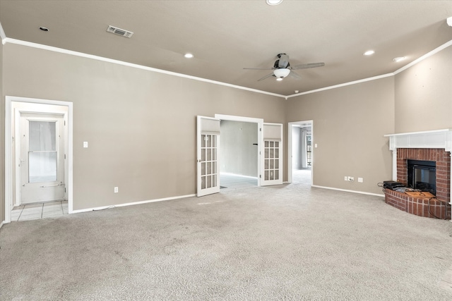 unfurnished living room featuring crown molding, light colored carpet, ceiling fan, and a fireplace