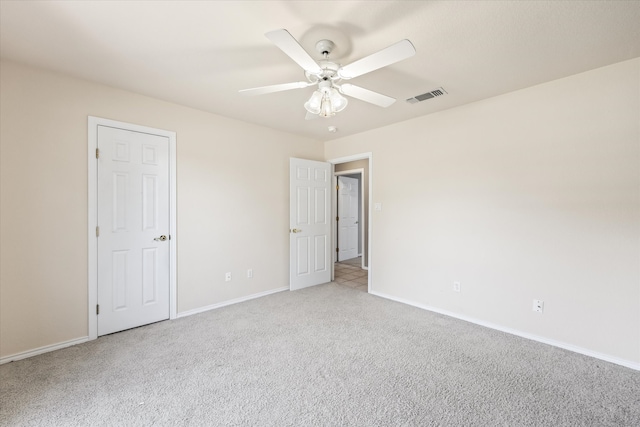 unfurnished bedroom with light carpet and ceiling fan