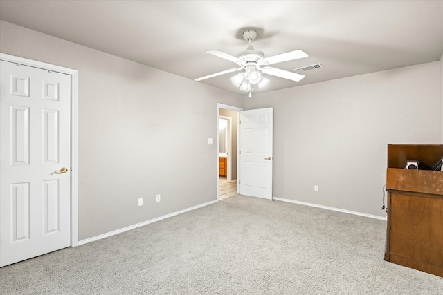 unfurnished bedroom with ceiling fan and light carpet