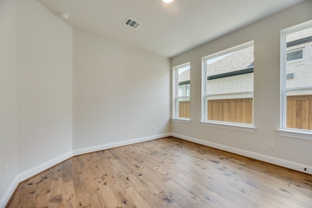 unfurnished room with light wood-type flooring