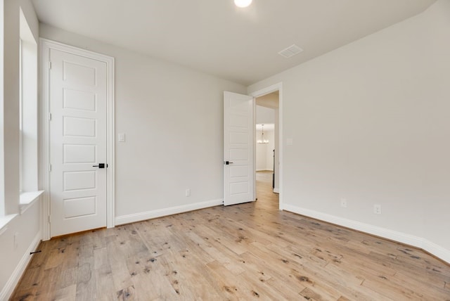 spare room with light wood-type flooring