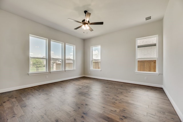 spare room featuring dark hardwood / wood-style floors and ceiling fan