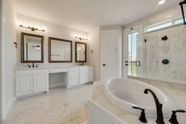 bathroom featuring a healthy amount of sunlight, marble finish floor, a marble finish shower, and a garden tub