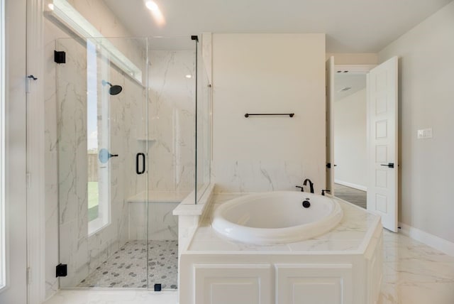 bathroom featuring marble finish floor, a garden tub, baseboards, and a marble finish shower