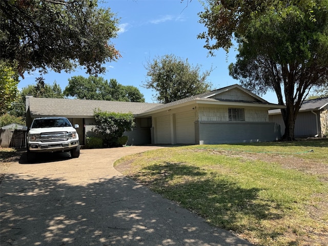 single story home with a front yard and a garage