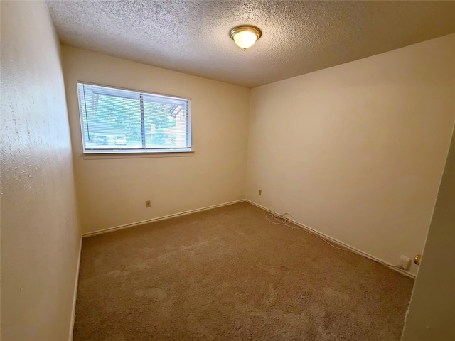 carpeted spare room featuring a textured ceiling