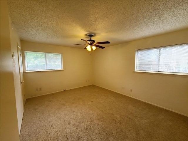 spare room featuring a textured ceiling, ceiling fan, and carpet floors