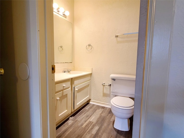 bathroom featuring hardwood / wood-style floors, toilet, and vanity