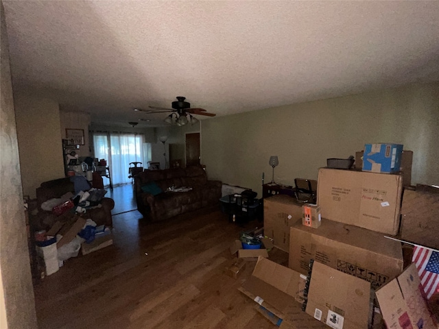 interior space featuring ceiling fan, wood-type flooring, and a textured ceiling