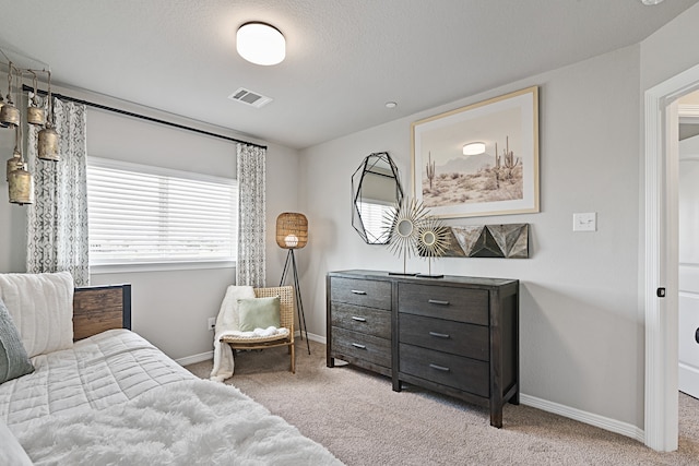 carpeted bedroom featuring a textured ceiling