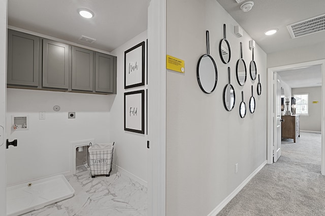 washroom featuring electric dryer hookup, light carpet, cabinets, and washer hookup