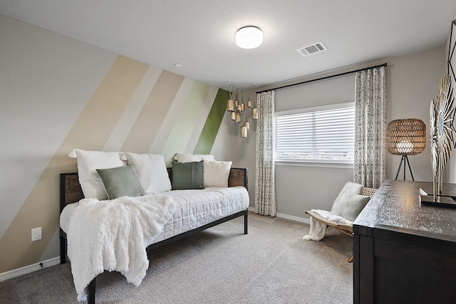 bedroom featuring carpet floors and a textured ceiling