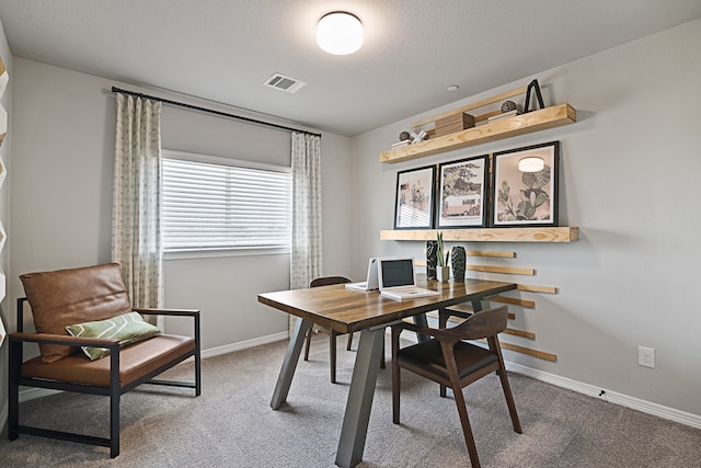 carpeted home office with a textured ceiling