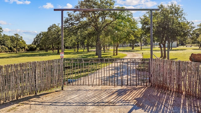 view of gate with a yard