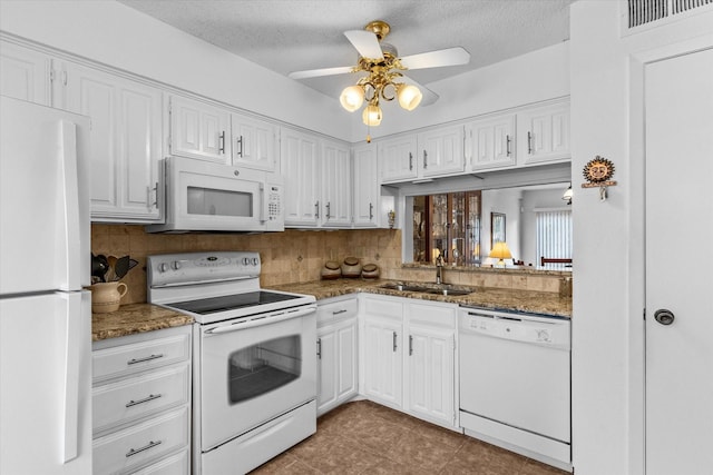 kitchen with sink, white cabinets, white appliances, and decorative backsplash