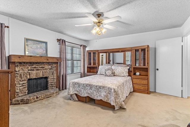 bedroom featuring a textured ceiling, carpet floors, and ceiling fan