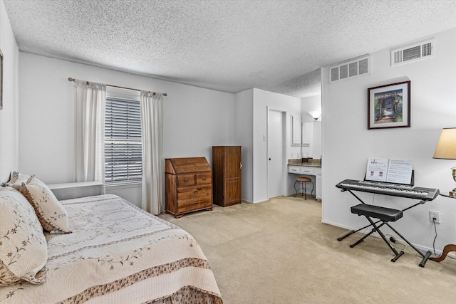 carpeted bedroom with a textured ceiling and ensuite bathroom