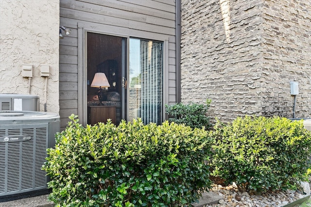 entrance to property featuring cooling unit