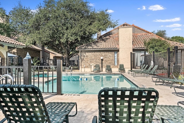 view of swimming pool with a patio area