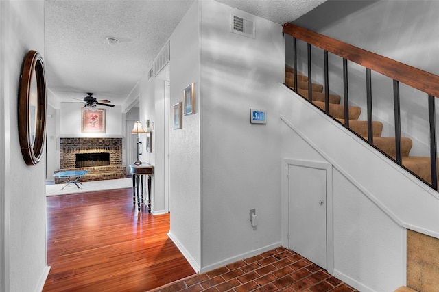 corridor with dark hardwood / wood-style flooring and a textured ceiling