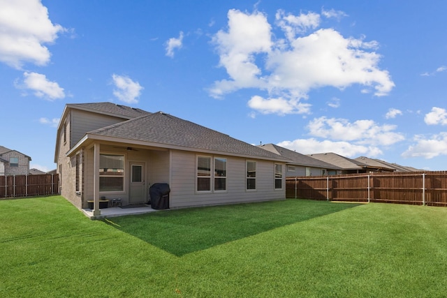 back of property featuring a yard