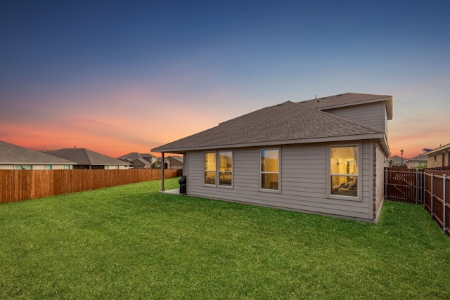 view of front of property with a garage and a lawn