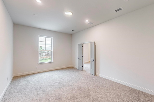 empty room featuring light colored carpet