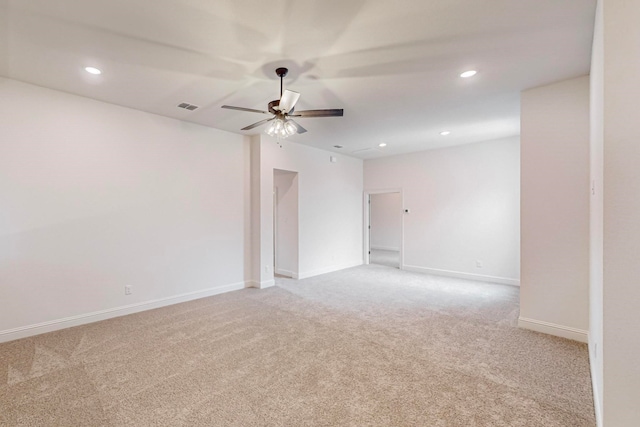 empty room with ceiling fan and light colored carpet