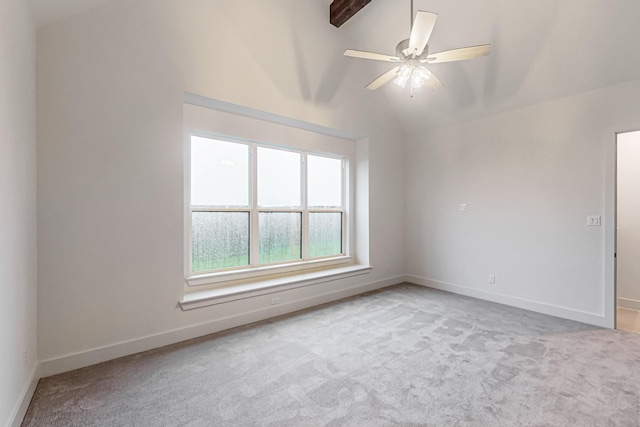 spare room featuring vaulted ceiling, ceiling fan, light carpet, and baseboards