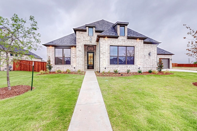 view of front of home featuring a garage and a front yard