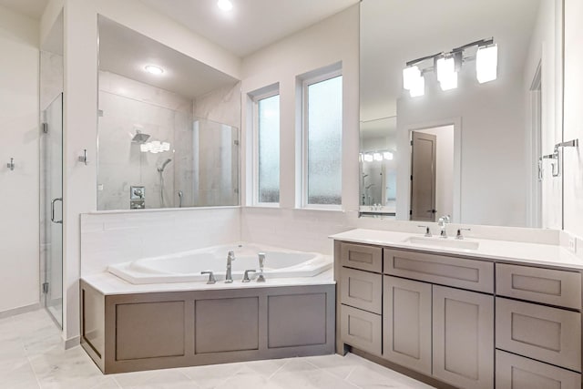 bathroom with a shower stall, vanity, and a bath