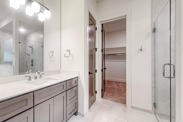 bathroom featuring vanity, tile patterned flooring, and an enclosed shower