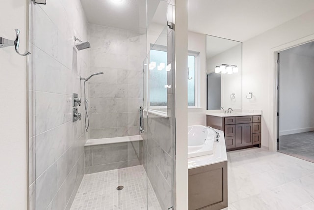 bathroom featuring a shower with door and vanity