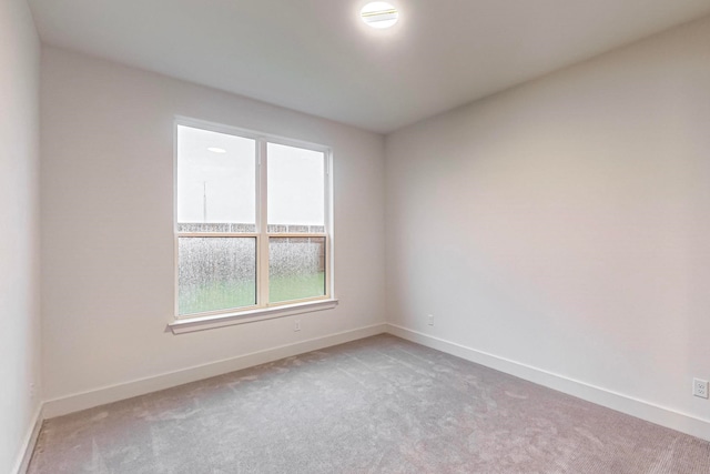 unfurnished room featuring light colored carpet