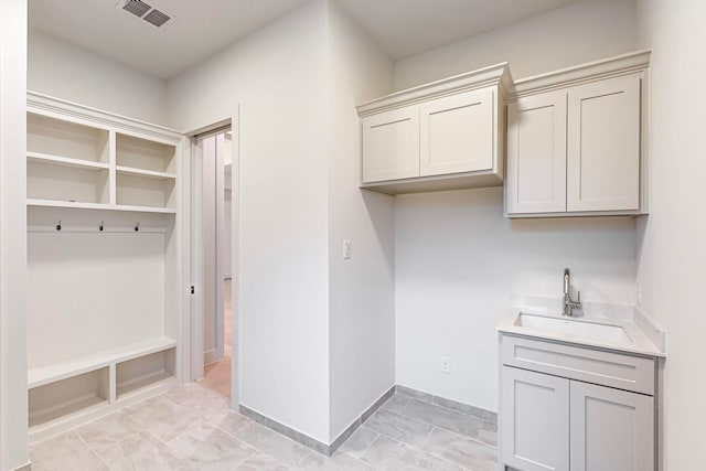 clothes washing area with sink