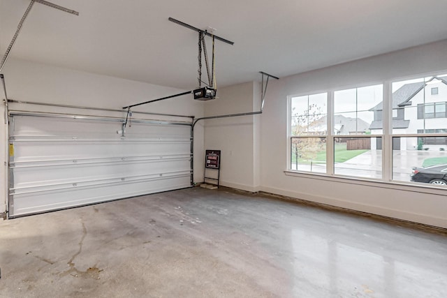 garage with a garage door opener and baseboards