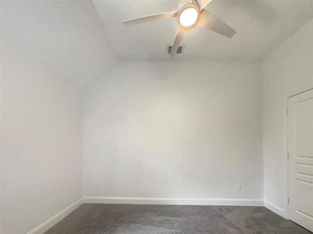 spare room featuring ceiling fan, dark colored carpet, visible vents, and baseboards