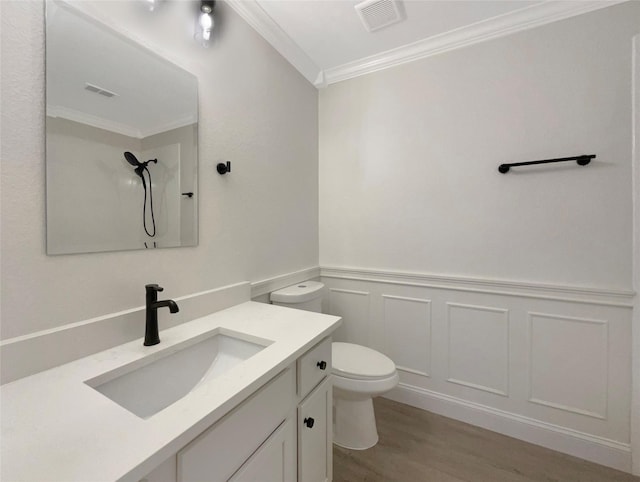 full bathroom with visible vents, toilet, ornamental molding, wood finished floors, and vanity