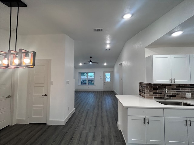 kitchen with hanging light fixtures, white cabinetry, sink, dark hardwood / wood-style floors, and ceiling fan