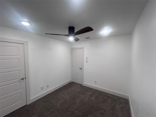 carpeted spare room featuring ceiling fan