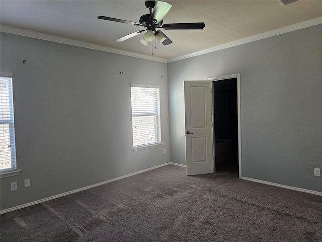 carpeted spare room featuring ceiling fan and crown molding