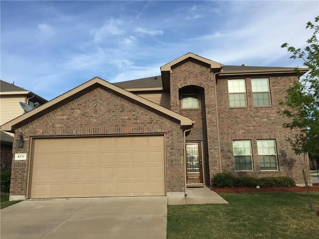 view of front facade with a garage and a front lawn