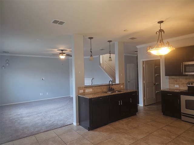 kitchen featuring decorative backsplash, light tile patterned flooring, decorative light fixtures, sink, and electric range