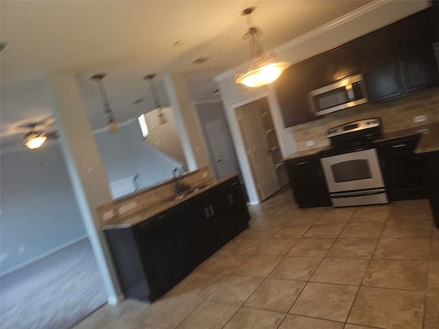 kitchen featuring light tile patterned floors, ornamental molding, tasteful backsplash, decorative light fixtures, and white range oven